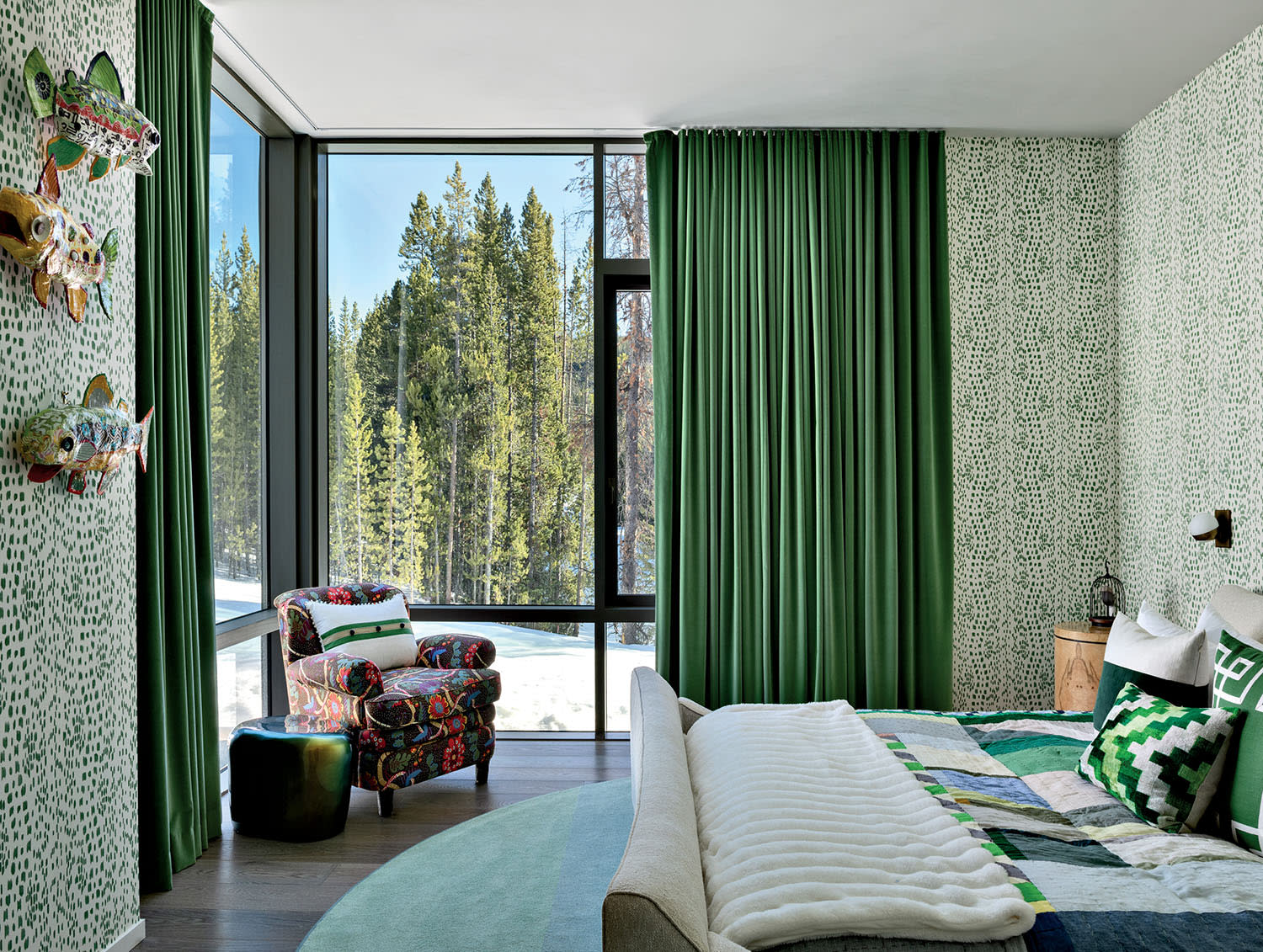 green guest bedroom with a textured wallcovering and emerald drapes