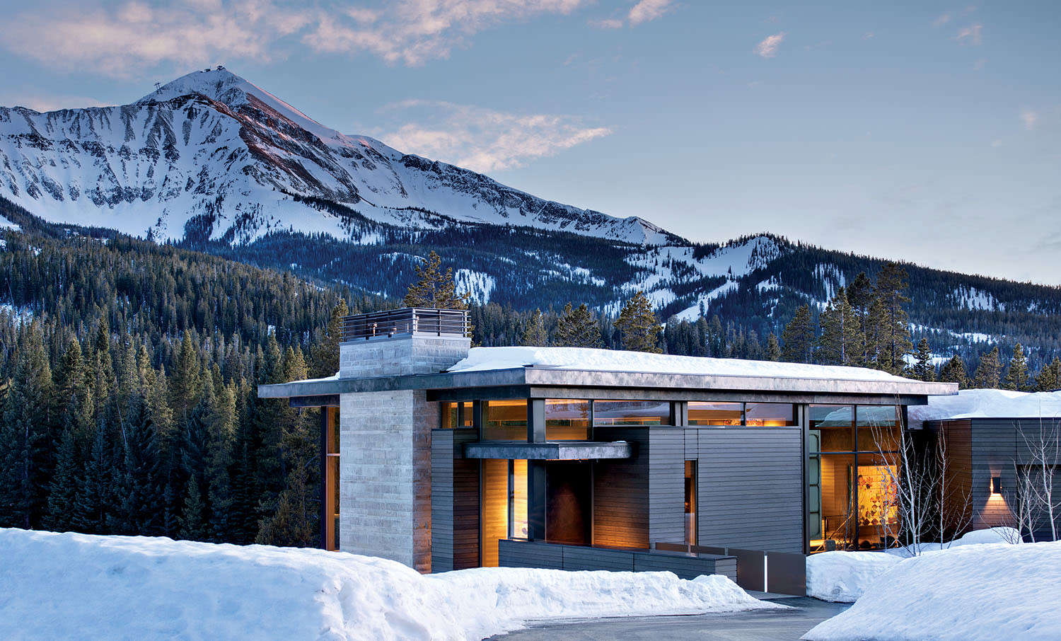 Big Sky home exterior of weathered cedar, sandstone and patinated stainless steel